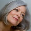 Gros plan sur une femme avec un carré gris lisse et un maquillage naturel